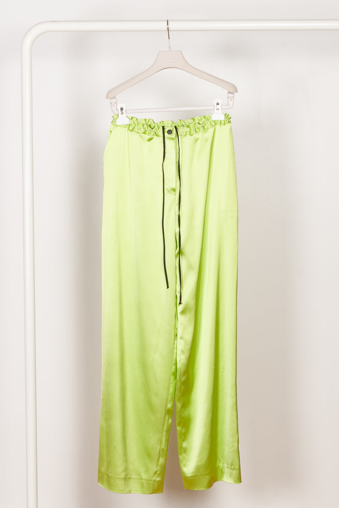 The Pyjama Trousers by Botter are relaxed silk drawstring trousers in a vibrant lime color