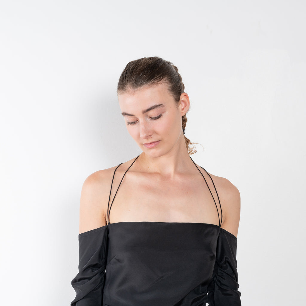The Samaca Mini Dress by GAUGE81 is a silk off-the-shoulder dress with fine straps both as a halter & crossed back