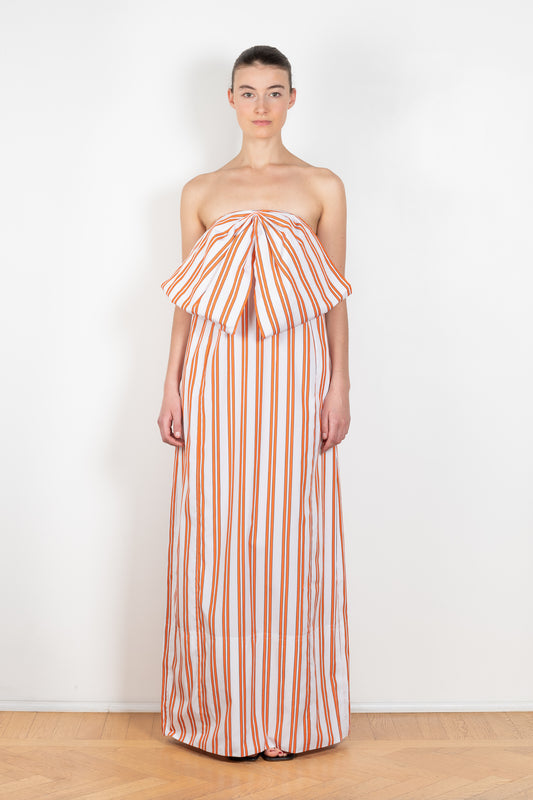 The Dance Floor Gown by Nackiye is a striped bustier dress with a front bow and a back slit