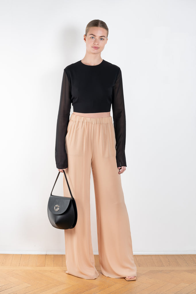 The Lena Pants by The Andamane are high waist silk trousers with a flattering wide leg in a silk chiffon summer blush