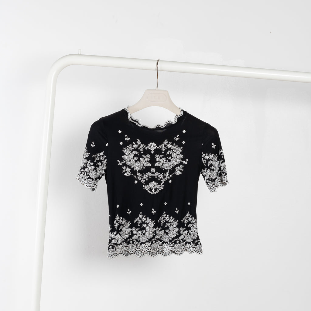 The Embroidered Top by Paco Rabanne is a lightweight nylon top with contrasted floral embroidery