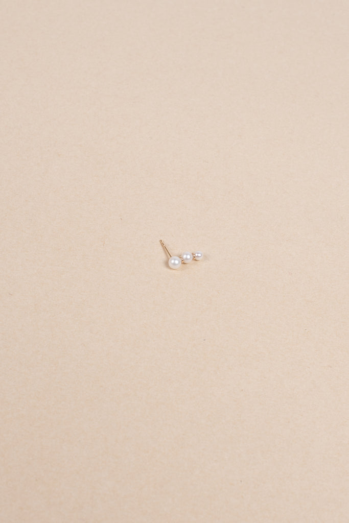 The Trois Perle Earring by Sophie Bille brahe is a delicate earring with pearls graduating in size, handcrafted in 14K yellow gold with freshwater pearls