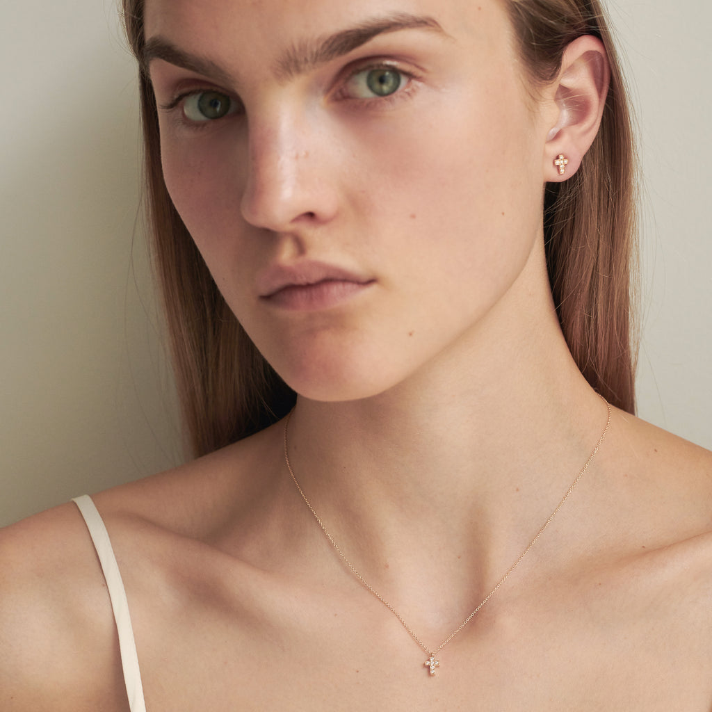 The Giulietta Necklace by Sophie Bille Brahe is a delicate necklace in 18K yellow gold and five 0.06 carat Top Wesselton VVS diamonds set in a cross shape