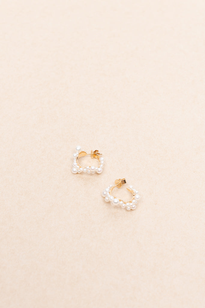 The Mary Hoop Earrings by Sophie Bille Brahe are Hoop earrings featuring white freshwater pearls varying in size, arranged intricately