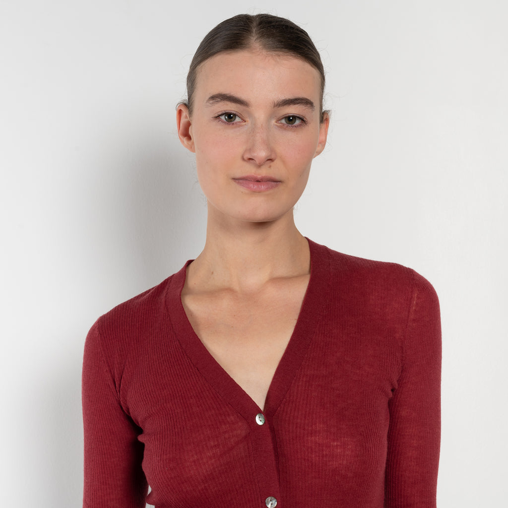 The Skinny Rib Cardigan by 6397 is a slightly sheer wool ribbed cardigan, a feminine piece to be worn as a top