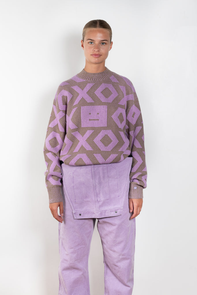 The Face Logo Jumper 82 by Acne Studios has an all-over seasonal face xo animation, detailed with a micro face logo patch on the sleeve cuff