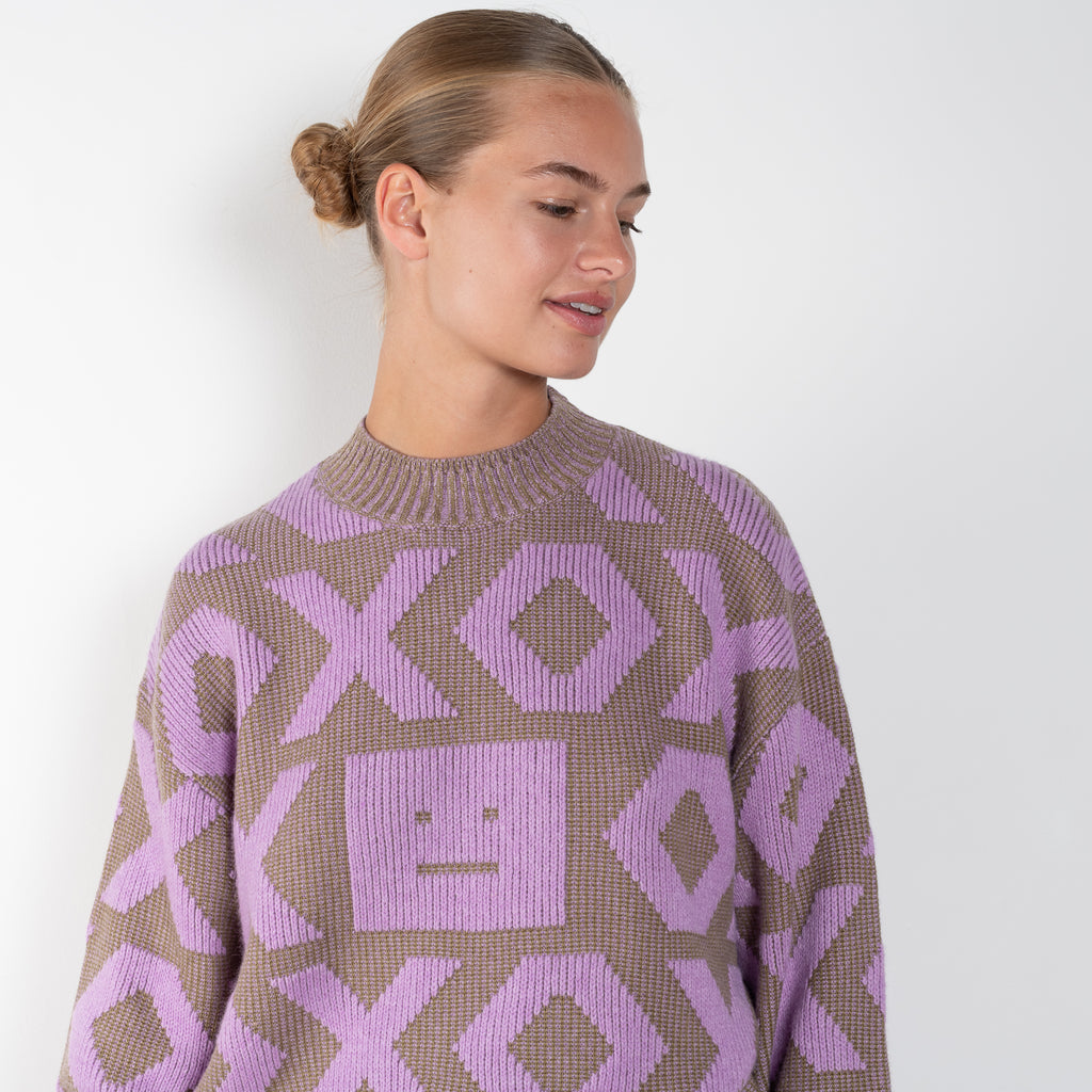 The Face Logo Jumper 82 by Acne Studios has an all-over seasonal face xo animation, detailed with a micro face logo patch on the sleeve cuff