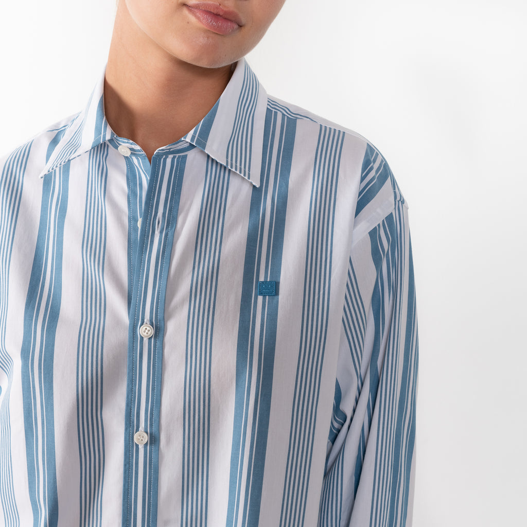 The Striped Shirt 51 by Acne Studios has an all-over stripe pattern and is detailed with a micro face logo embroidery on the chest and a face logo on the back