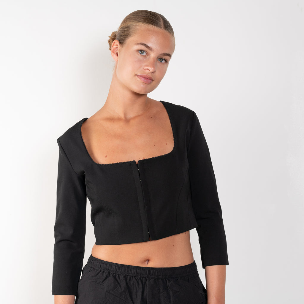 The Hooked Top 852 by Acne Studios is a cropped top with front hook and eye closure, a square-cut neckline and a zipper closure