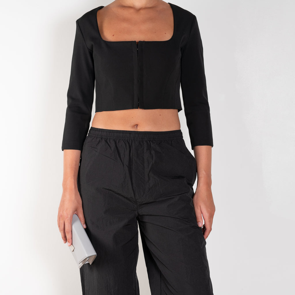 The Hooked Top 852 by Acne Studios is a cropped top with front hook and eye closure, a square-cut neckline and a zipper closure