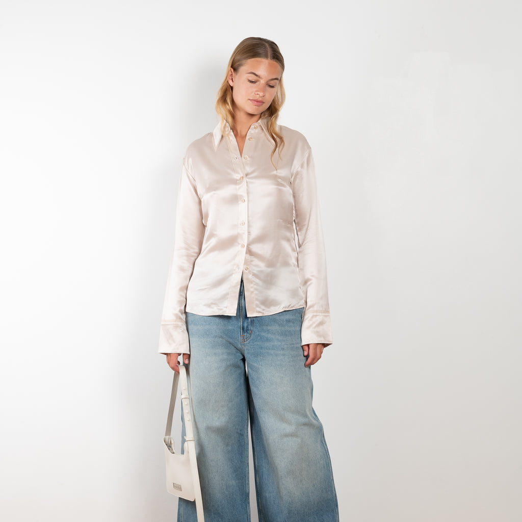The Silk Shirt 925 by Acne Studios is detailed with contrast fabric raw edges on the collar and cuffs in a fluid silk blend 