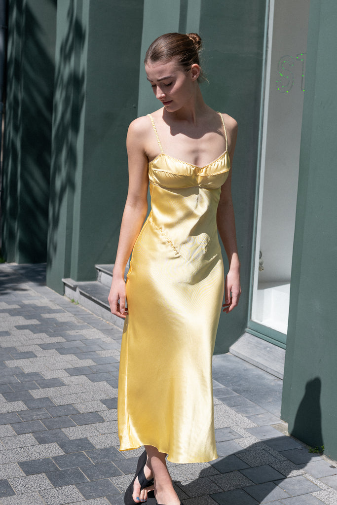 The Waterlily Midi Dress by Anna October is a signature lightweight summer dress with an open back and lingerie details