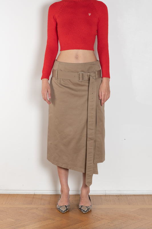 The Belted Twill Skirt by Acne Studios is crafted from classic cotton twill, featuring a trench-style belt at the hip with a leather buckle and embroidered eyelets