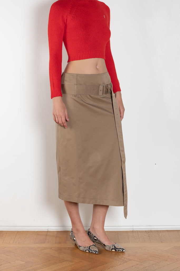 The Belted Twill Skirt by Acne Studios is crafted from classic cotton twill, featuring a trench-style belt at the hip with a leather buckle and embroidered eyelets