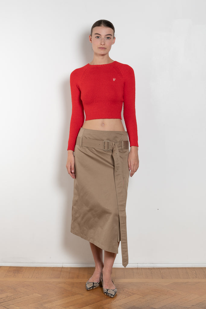 The Belted Twill Skirt by Acne Studios is crafted from classic cotton twill, featuring a trench-style belt at the hip with a leather buckle and embroidered eyelets