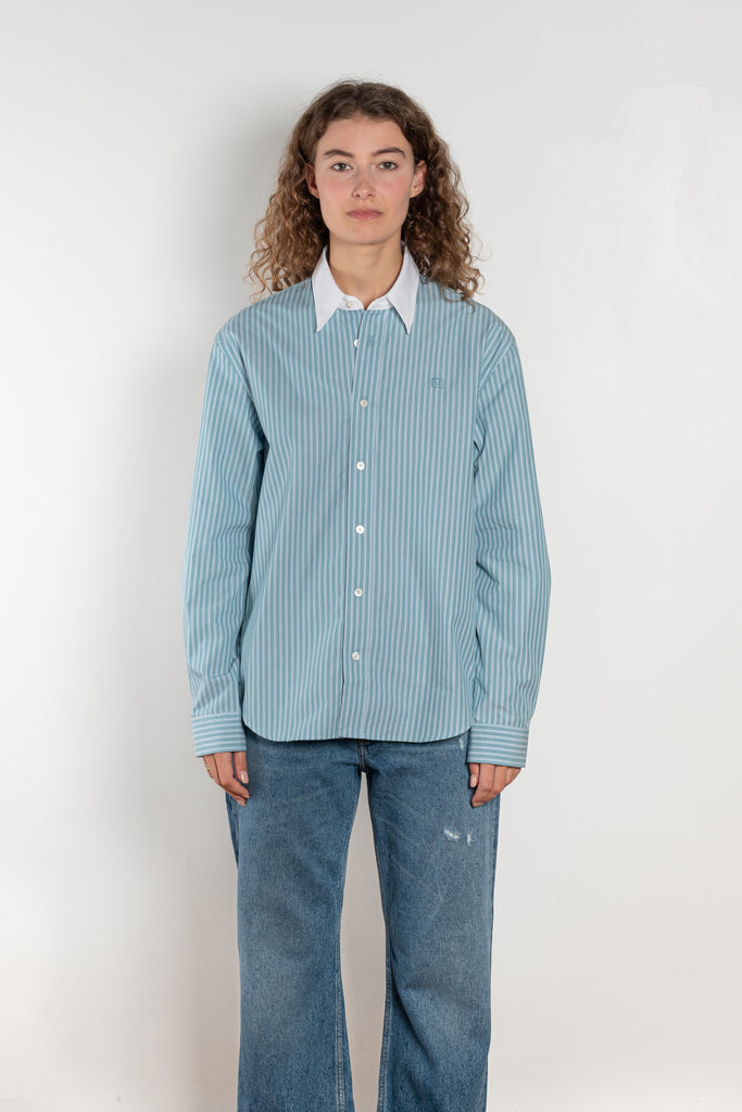 The Button Up Shirt by Acne Studios is a long sleeve button-up shirt with a stripe pattern and contrast collar
