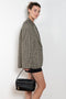 The Camero bag by Acne Studios features a multipocket typology with a soft, rectangular design and a compact, structured silhouette