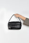 The Camero bag by Acne Studios features a multipocket typology with a soft, rectangular design and a compact, structured silhouette