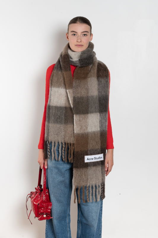 The Mohair Checked Scarf by Acne Studios is crafted from a wool mohair blend detailed with an embroidered logo label.

