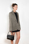 The Check Suit Jacketby Acne Studios is a single-breasted suit jacket with a check bicolour pattern