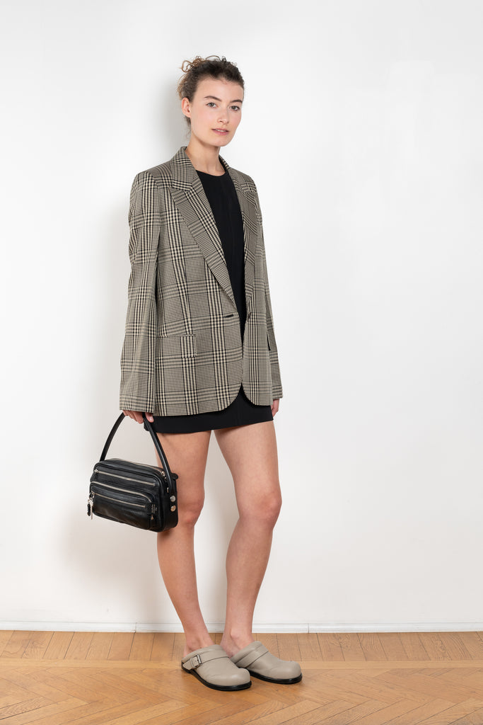 The Check Suit Jacketby Acne Studios is a single-breasted suit jacket with a check bicolour pattern