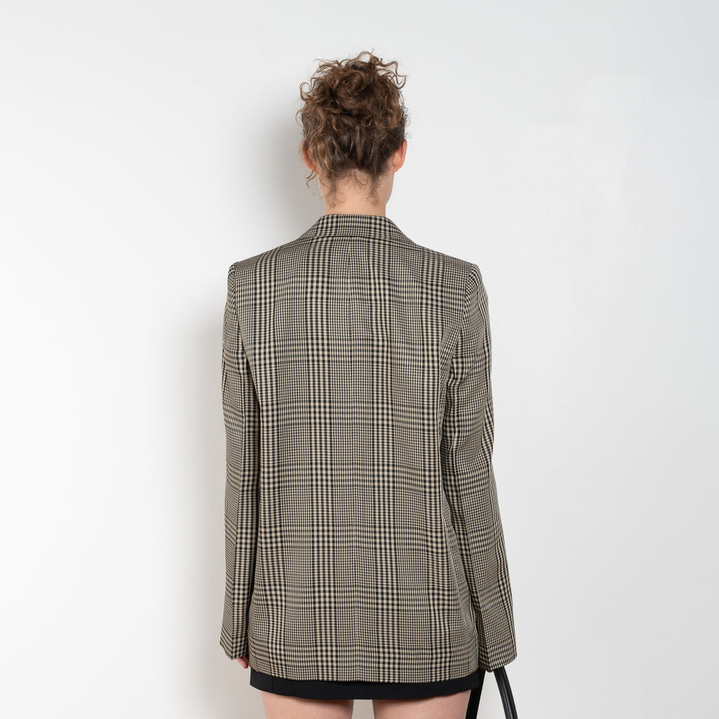 The Check Suit Jacketby Acne Studios is a single-breasted suit jacket with a check bicolour pattern