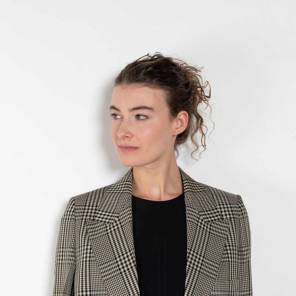 The Check Suit Jacketby Acne Studios is a single-breasted suit jacket with a check bicolour pattern