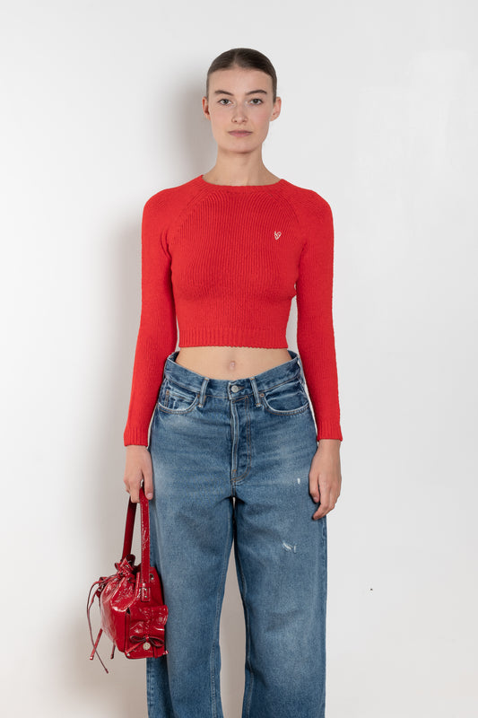 The Cropped Crewneck Sweater by Acne Studios has a fitted silhouette, featuring 3/4-length sleeves and a cropped length