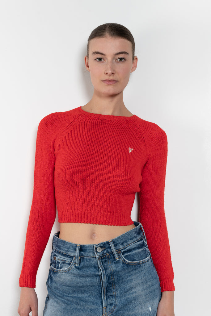 The Cropped Crewneck Sweater by Acne Studios has a fitted silhouette, featuring 3/4-length sleeves and a cropped length