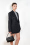 The Pinstripe Jacket by Acne Studios is a double-breasted suit jacket in a wool blend yarn pinstripe woven in a fine herringbone structure and drape finish