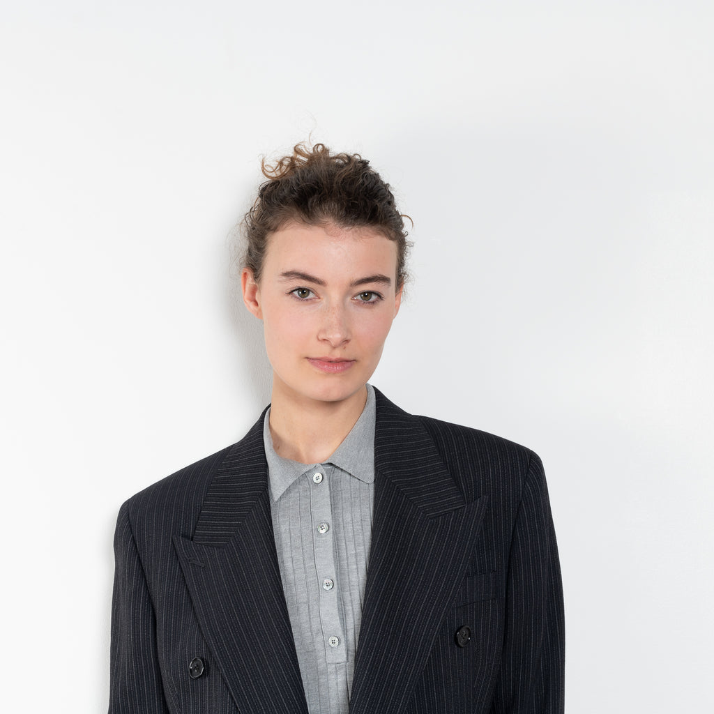 The Pinstripe Jacket by Acne Studios is a double-breasted suit jacket in a wool blend yarn pinstripe woven in a fine herringbone structure and drape finish