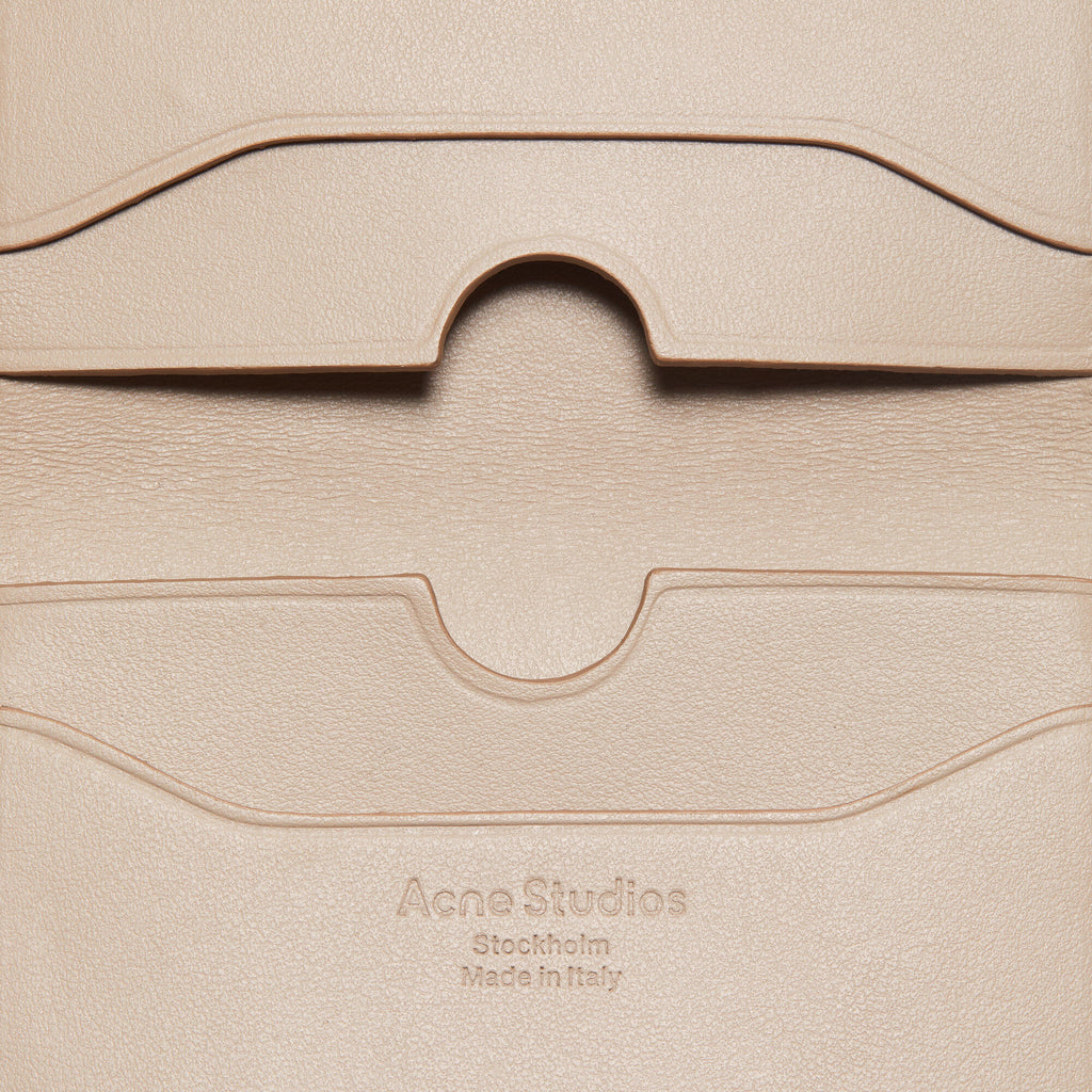 The Folded Leather Wallet by Acne Studios features a folded opening with card slot compartments, crafted from smooth leather and detailed with an Acne Studios logo on the front