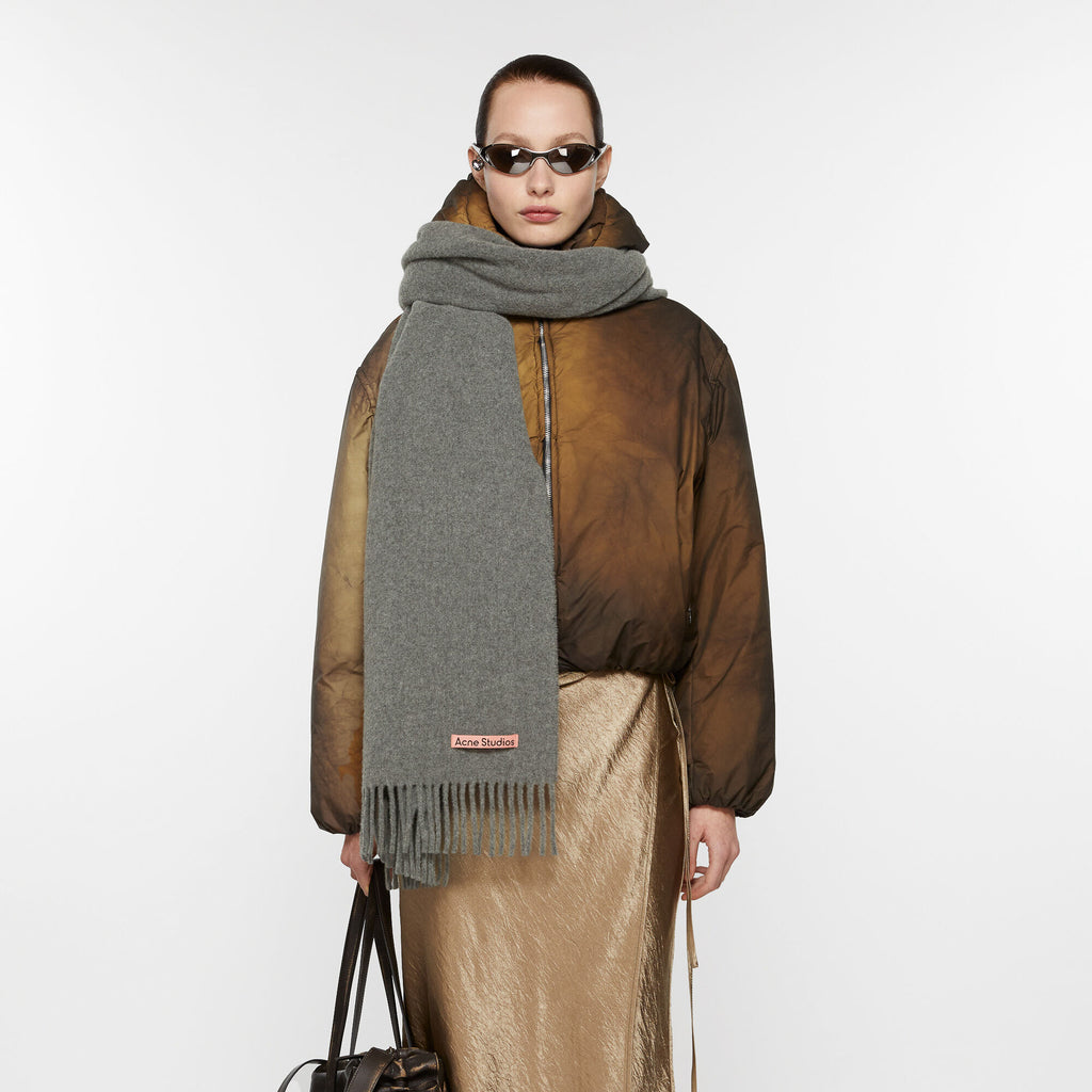 The Oversized Fringed Scarf by Acne Studios is crafted from midweight wool with a soft hand-feel, detailed with a pink Acne Studios label