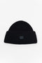 The Small Face Logo Beanie by Acne Studios features a small embroidered face logo patch and ribbed detailing, crafted from chunky wool.
