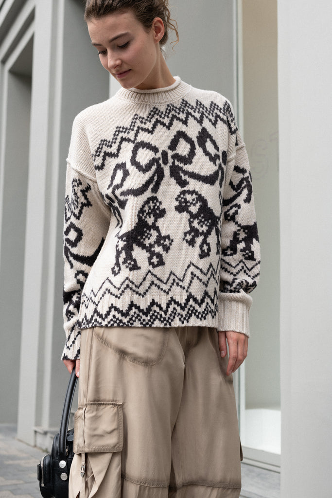 The Jacquard Sweater 818 by Acne Studios is a crew neck sweater with a relaxed fit and below hip length. Detailed with an all-over jacquard seasonal animation.