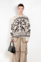 The Jacquard Sweater 818 by Acne Studios is a crew neck sweater with a relaxed fit and below hip length. Detailed with an all-over jacquard seasonal animation.
