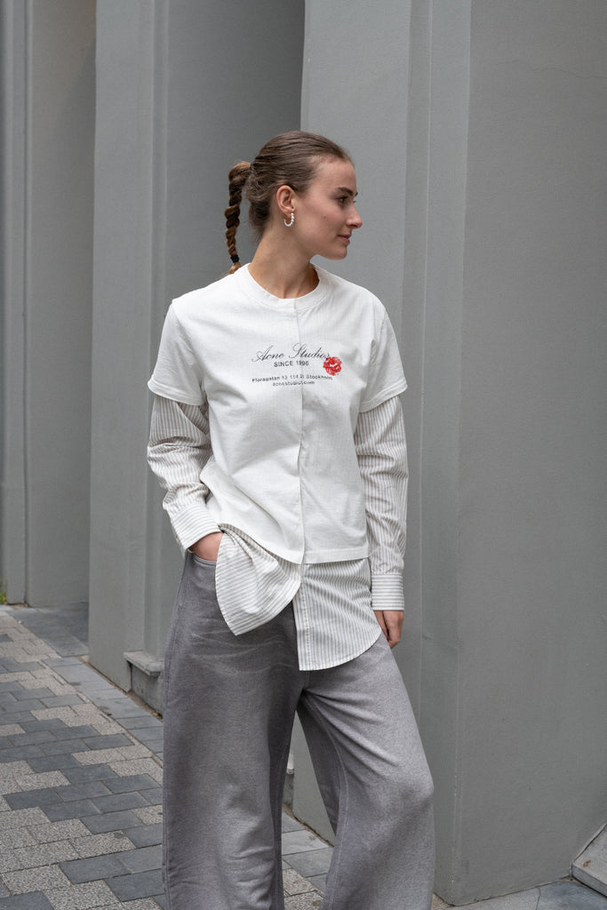The Layered Shirt by Acne Studios is a layered t-shirt with a relaxed fit and integrated long sleeve shirt with base-ball inspirations