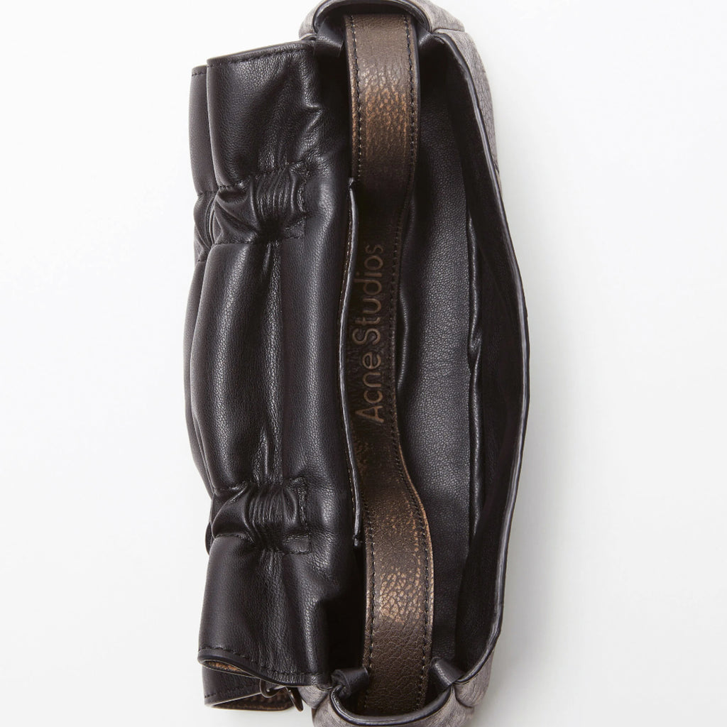 The Multipocket Micro Bag by Acne Studios is crafted from leather with a washed finish and laced knot details