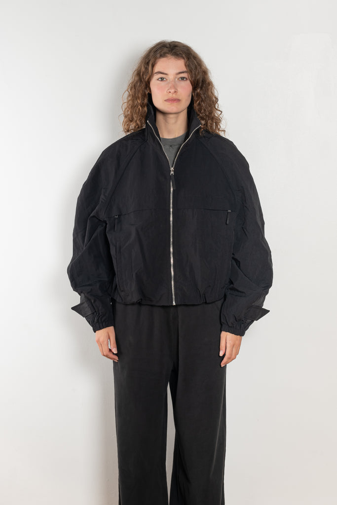 The Nylon Jacket by Acne Studios is crafted in a technical nylon with a peach finish. Constructed with a high neckline