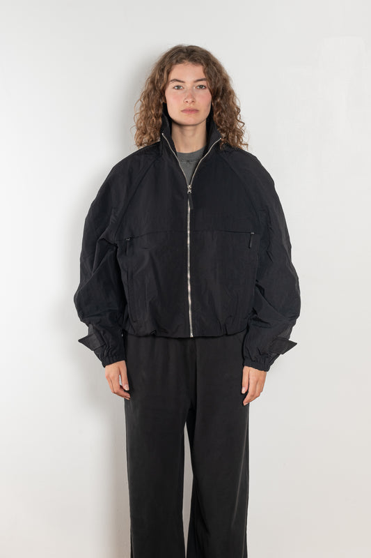 The Nylon Jacket by Acne Studios is crafted in a technical nylon with a peach finish. Constructed with a high neckline