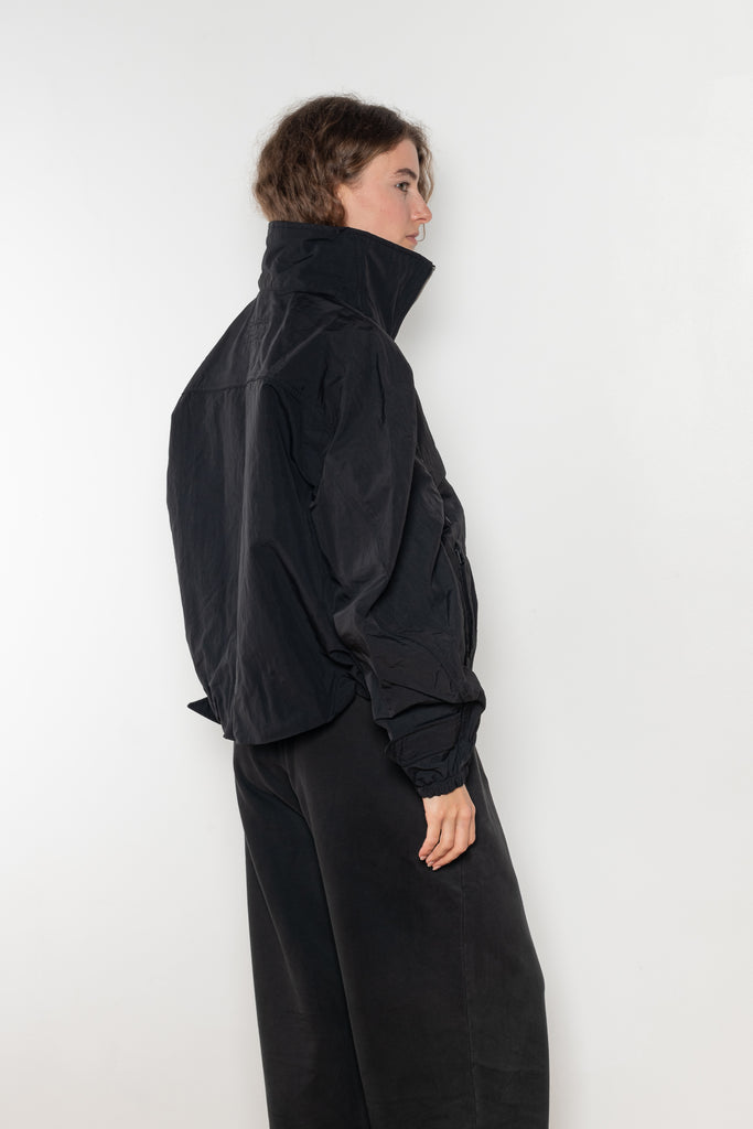The Nylon Jacket by Acne Studios is crafted in a technical nylon with a peach finish. Constructed with a high neckline