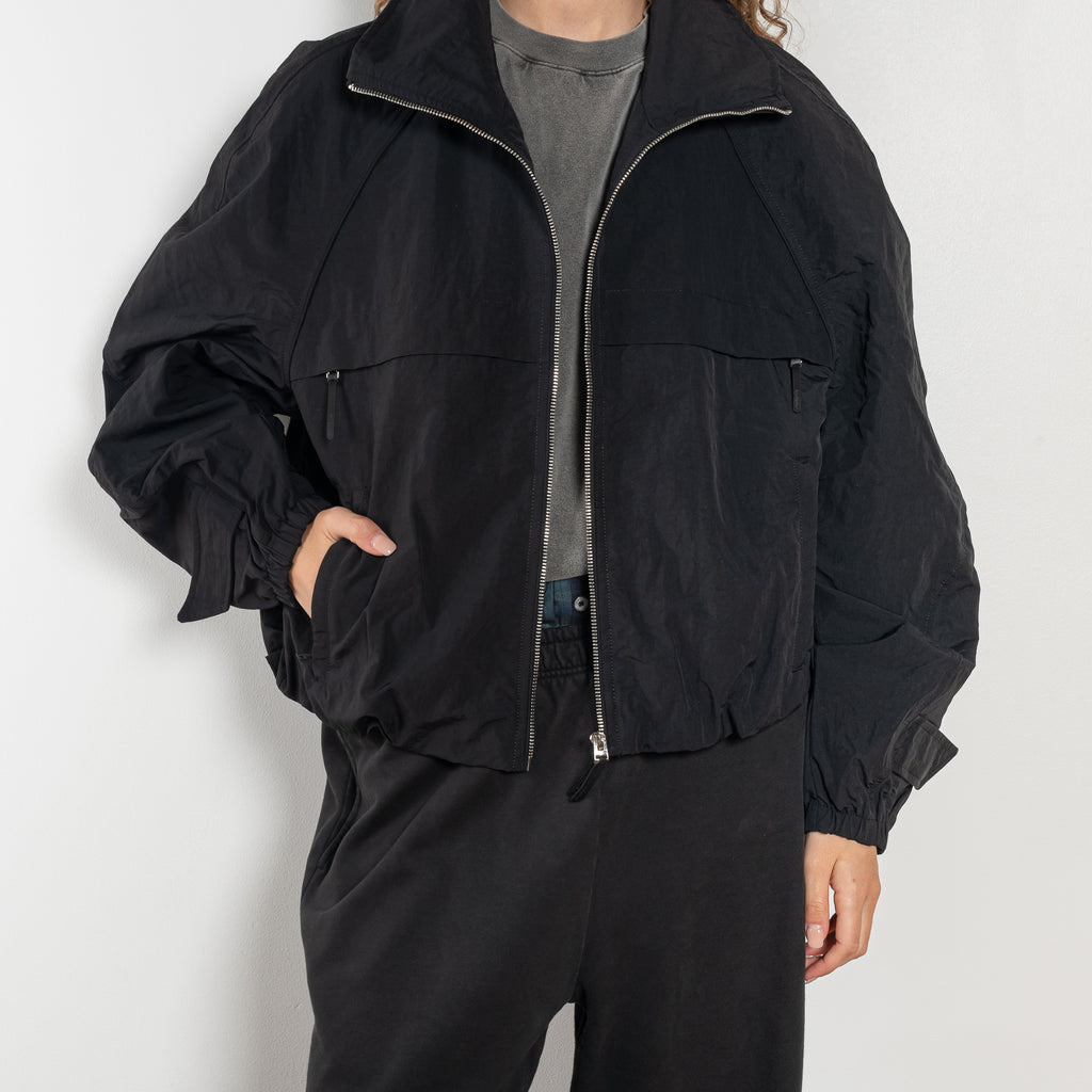 The Nylon Jacket by Acne Studios is crafted in a technical nylon with a peach finish. Constructed with a high neckline