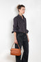 The Shirt Jacquard Pinstripe by Acne Studios is a button-up shirt in poplin cotton with a contrast bow embroidery