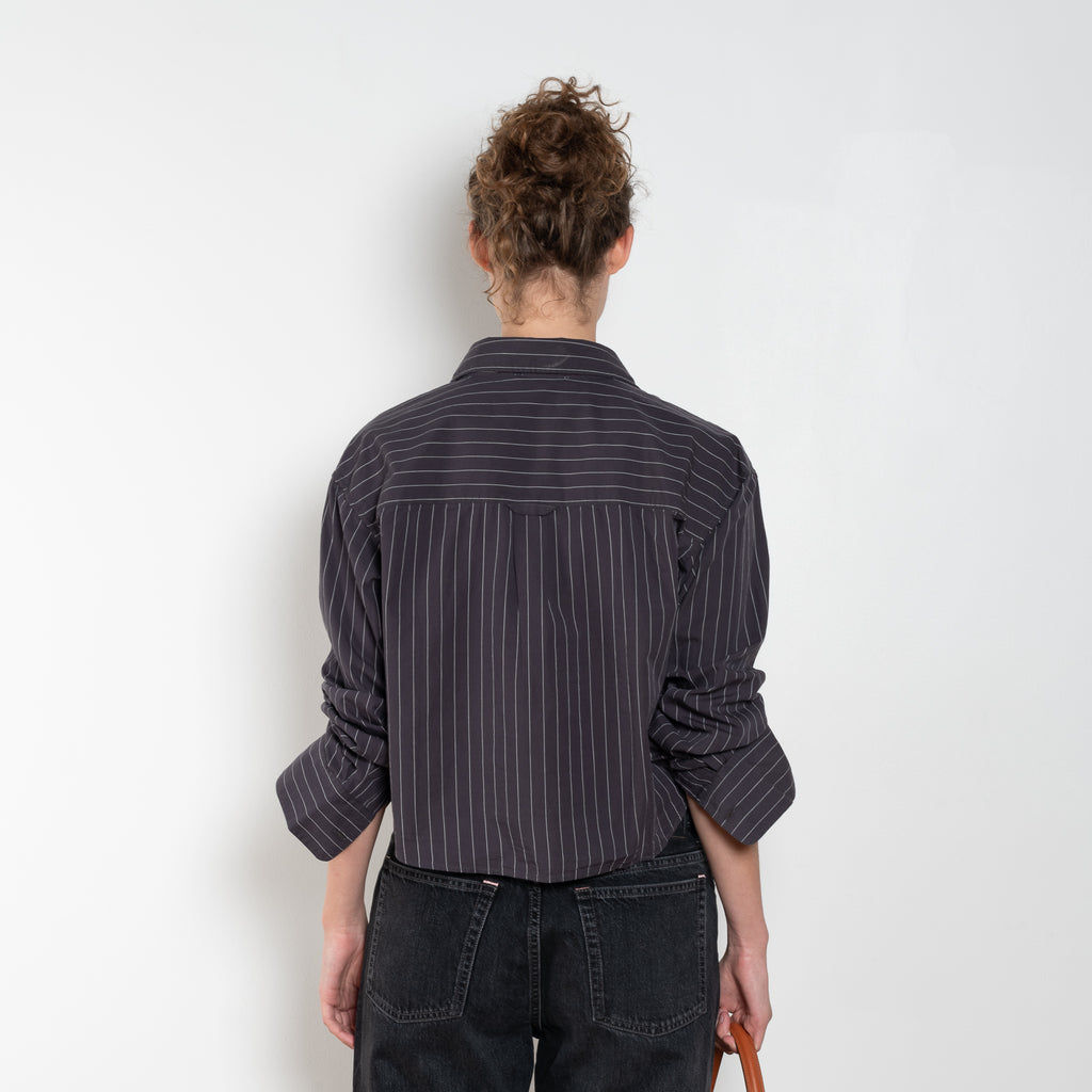 The Shirt Jacquard Pinstripe by Acne Studios is a button-up shirt in poplin cotton with a contrast bow embroidery
