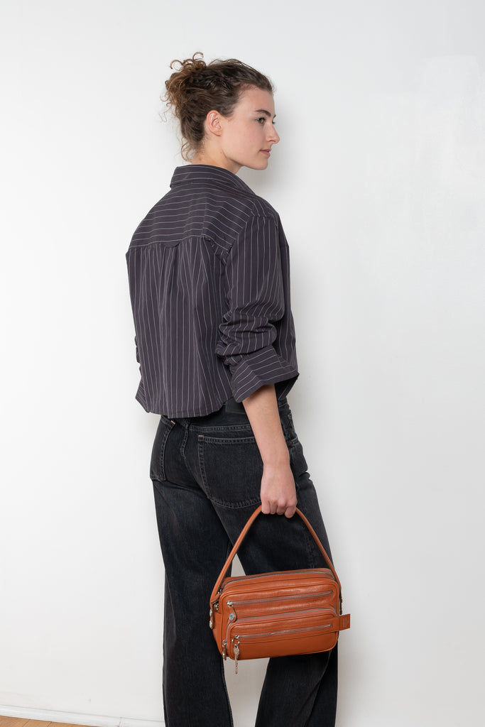 The Shirt Jacquard Pinstripe by Acne Studios is a button-up shirt in poplin cotton with a contrast bow embroidery
