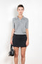 The Short sleeve polo shirt by Acne Studios is a lightweight ribbed silk polo top, detailed with a silver-toned logo engraved heart charm at the back