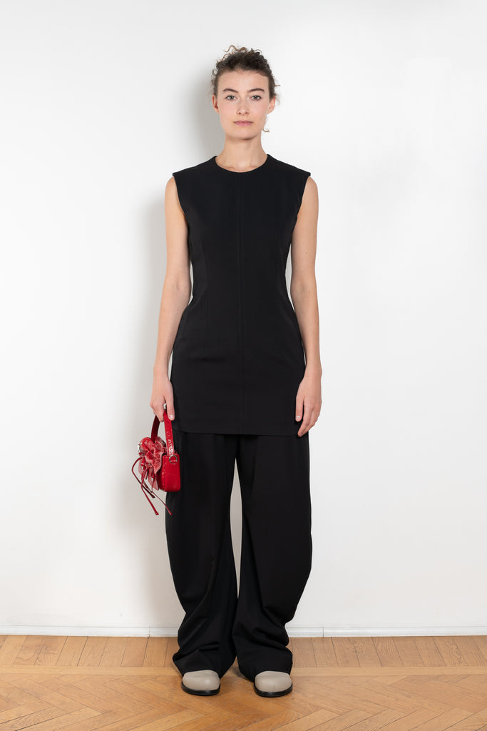 The Short Sleeve Dress by Acne Studios is a tailored dress made from a wool blend, detailed with darts along the waist