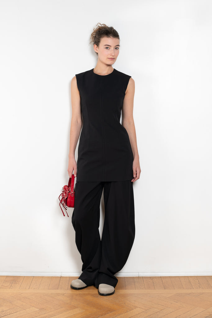 The Short Sleeve Dress by Acne Studios is a tailored dress made from a wool blend, detailed with darts along the waist