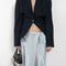 The Silk Wrap Skirt by Acne Studios is a silk A-line skirt with a wrap construction, featuring silver-toned bell and hardware details with a tonal tie-up closure