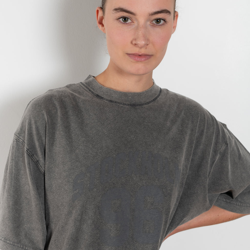 The Tshirt Dress by Acne Studios is a short-sleeve T-shirt dress featuring a layered construction